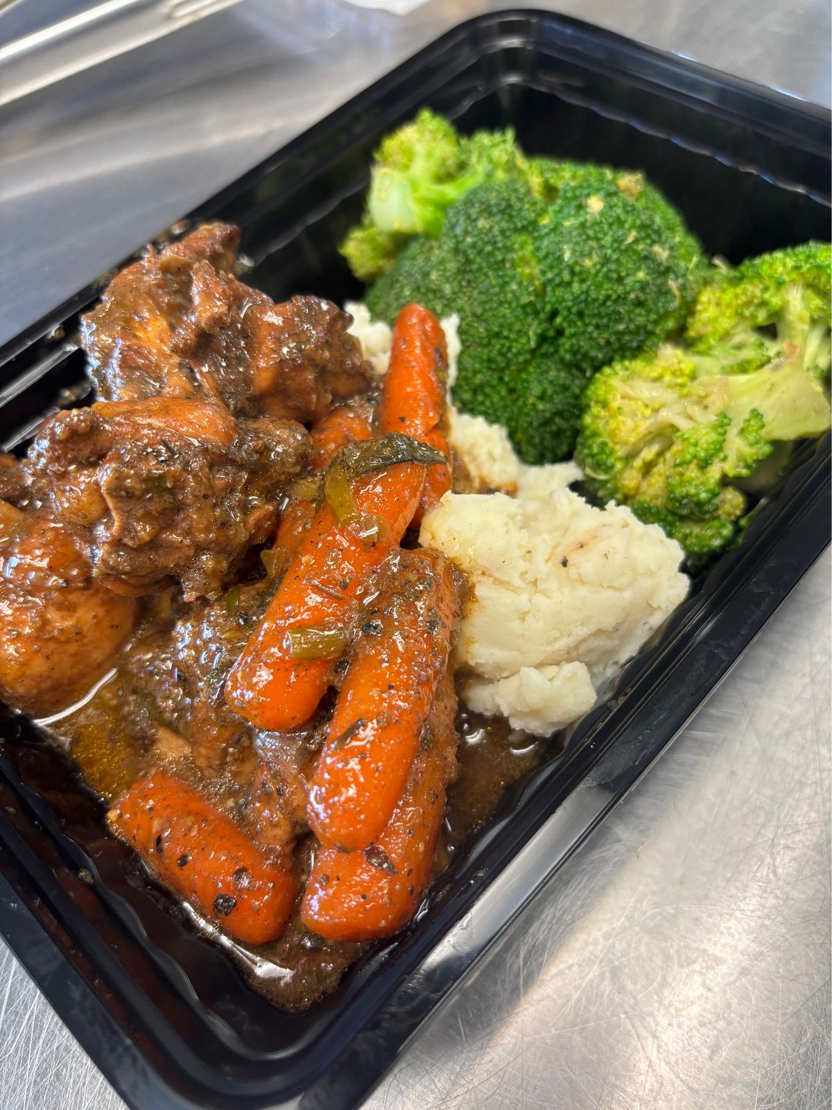 A portioned chicken and vegetable meal ready for delivery