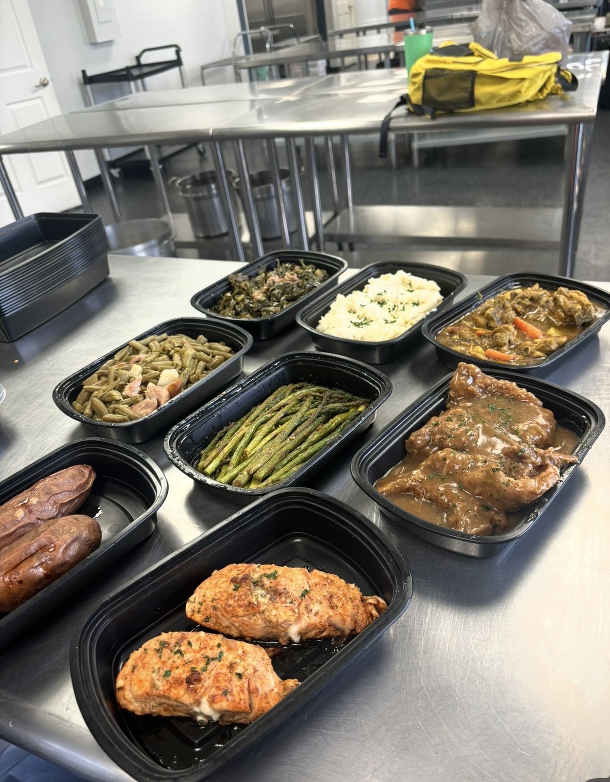 Prepared meal trays lined up on the kitchen prep table