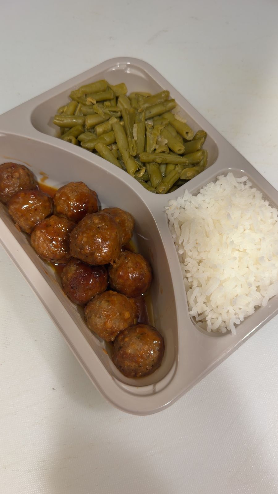 A tray of meatballs prepared for a childcare center lunch service