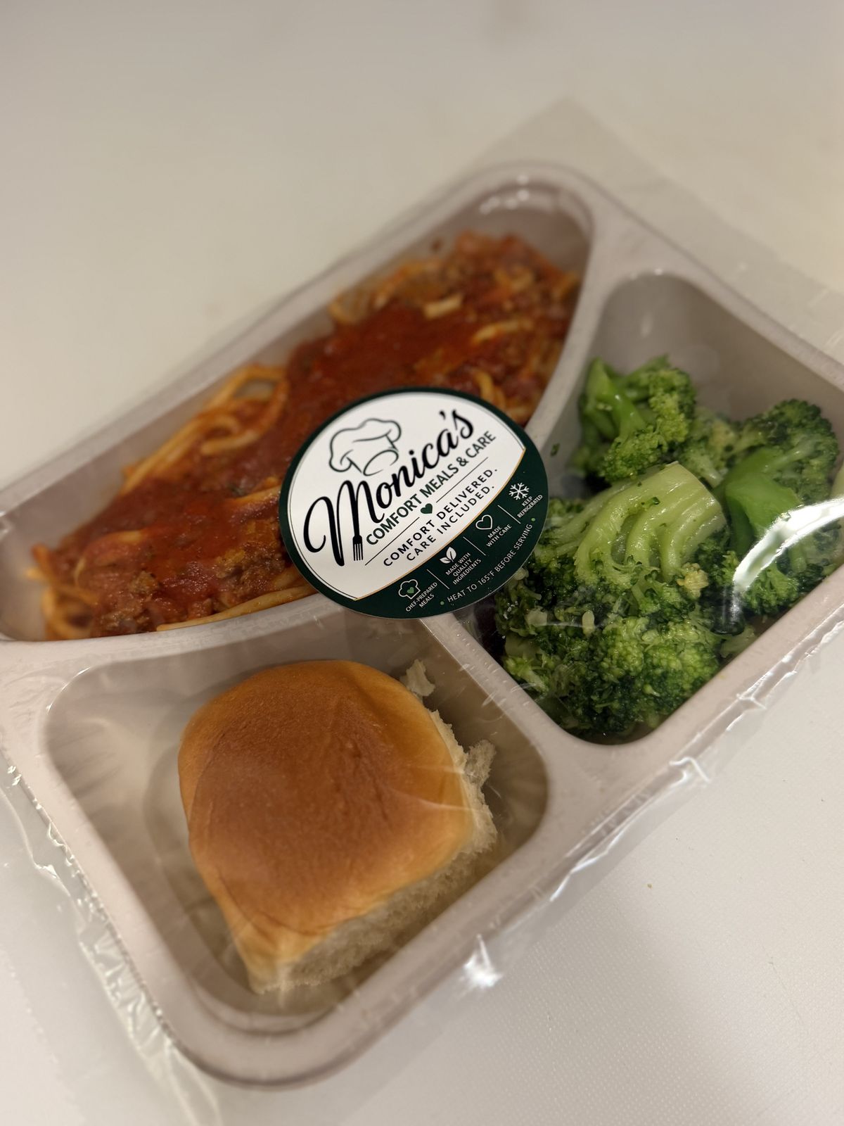 A sealed meal tray carrying the Monica's Comfort Meals and Care seal